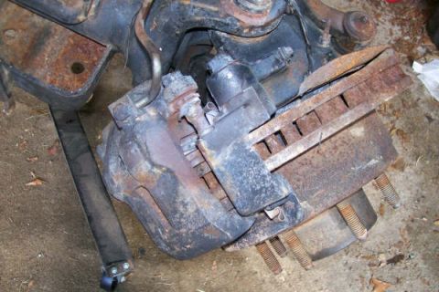 1988 Ford Bronco - Close-up view of a Dana 60 front axle brake caliper and rotor assembly.