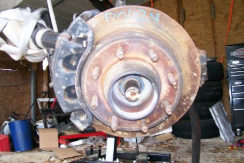 1988 Ford Bronco - Close-up of a Dana 60 front axle hub and rotor assembly, likely for a truck or SUV.