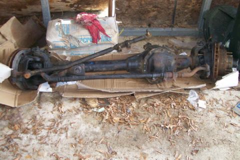 1988 Ford Bronco - This is a front axle assembly, likely from a truck or SUV, resting on cardboard.