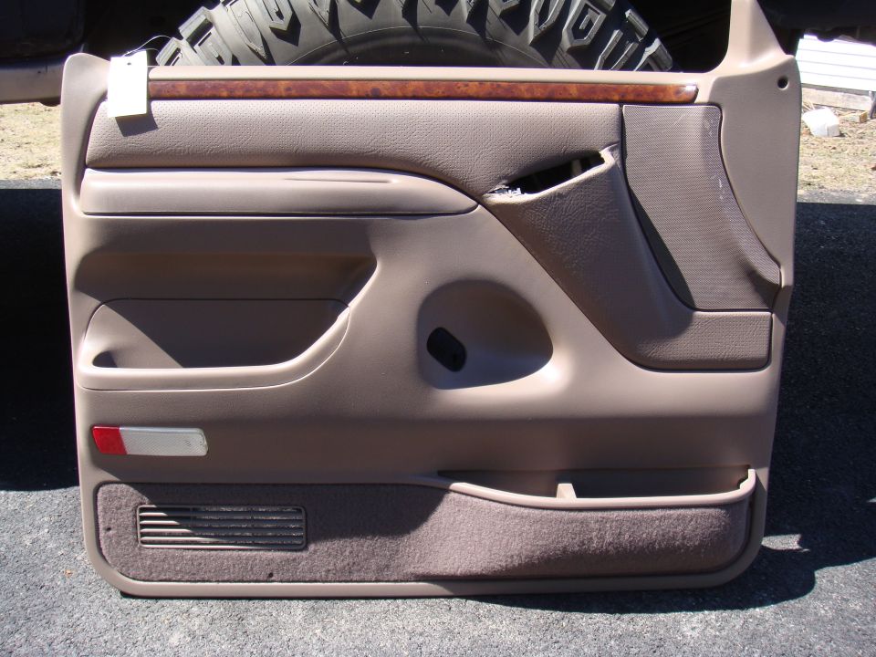 1996 Ford Bronco door panel with wood trim and storage pocket