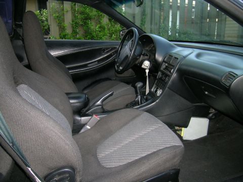 1993 Ford Probe - The interior of a car is visible, including the seats, dashboard, and steering wheel.