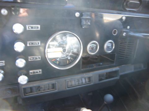 1986 Ford Bronco - The interior dashboard of a Jeep CJ shows the speedometer, fuel gauge, and temperature gauge.