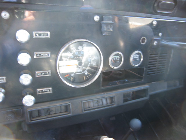 Jeep CJ dashboard with round speedometer and auxiliary gauges