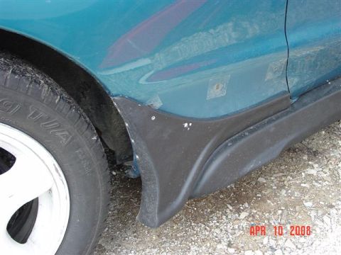 1993 Ford Probe - Detail of a car's side panel and fender, with visible tape marks and a black plastic trim piece.