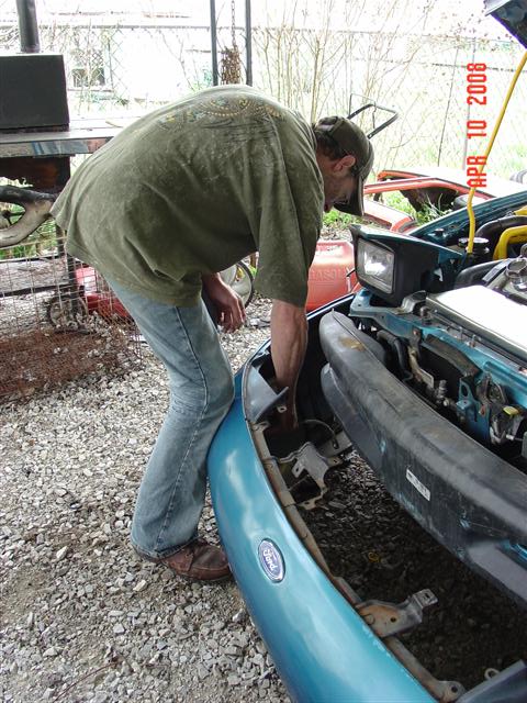 1993 Ford Probe - Working on the front end of a 1993 Ford Probe, with the bumper removed for access.