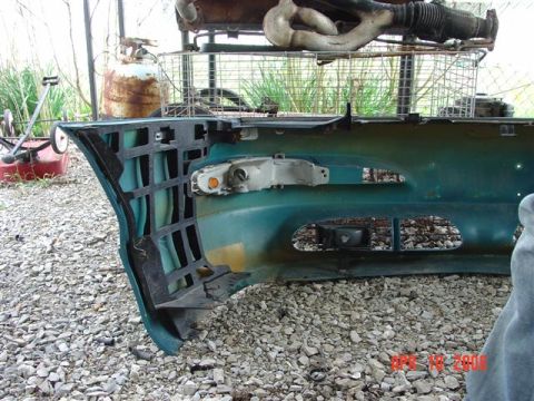1993 Ford Probe - A teal bumper with a turn signal and grille openings is shown, with a watermark indicating it was photographed in 2010.