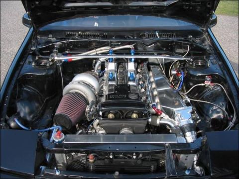 1991 Ford Probe - The engine bay features a large turbocharger and custom intake system.