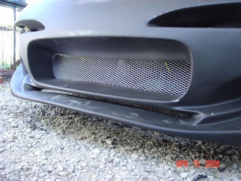 1993 Ford Probe - Close-up of a car's front bumper and grille, with a watermark indicating the source.