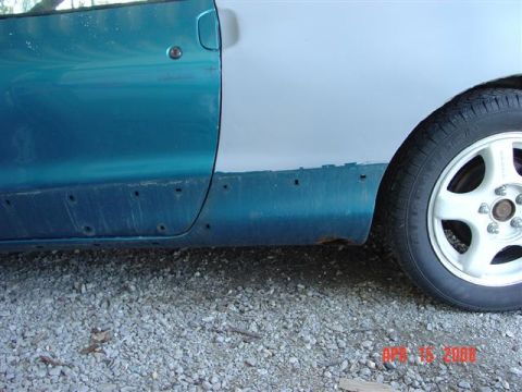 1993 Ford Probe - Side view of a 1993 Ford Probe, detailing rust and preparation for bodywork.