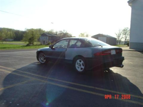 1993 Ford Probe - A 1993 Ford Probe is seen from a 3/4 front angle, with unfinished body panels on the driver's side.