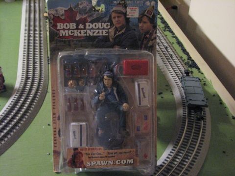 1991 Ford Bronco - Bob & Doug McKenzie action figure toy in packaging, displayed on a model train track.