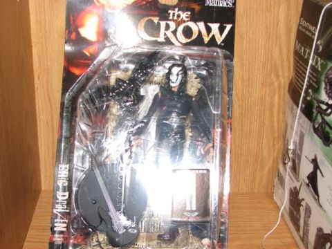 1991 Ford Bronco - The Crow action figure, packaged for sale, includes a guitar accessory.