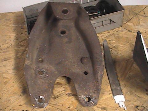 1980 Dodge Magnum - Close-up of a rusty metal suspension component with multiple mounting holes.