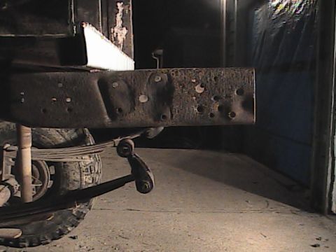 1980 Dodge Magnum - Close-up view of a rusty truck frame rail, showing suspension components.