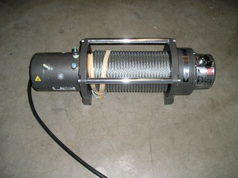 1986 Toyota Hilux - An electric winch with a steel cable is shown on a concrete floor.