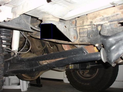 1990 Ford Bronco - Close-up of the undercarriage, focusing on the suspension and frame structure.