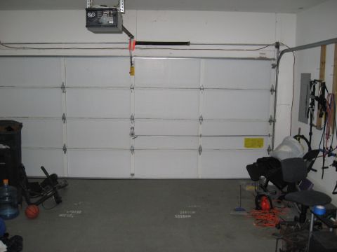 2006 Ford F-150 - Interior view of a garage with a large white door and various items stored around the space.