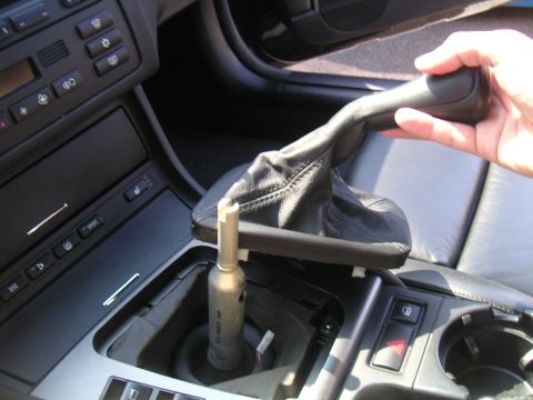 2002 BMW M3 - Close-up of a car's center console with the gear shift knob and boot removed, revealing the mechanism underneath.