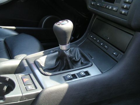 2002 BMW M3 - Interior view of a 2002 BMW M3's center console, focusing on the gear shifter and surrounding controls.