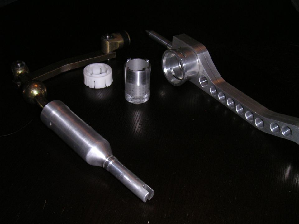 Stock shift lever beside billet aluminum short shifter arm, bushings and sleeve