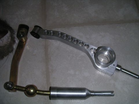 2002 BMW M3 - Aftermarket shift knob and linkage components are laid out on a tiled surface.