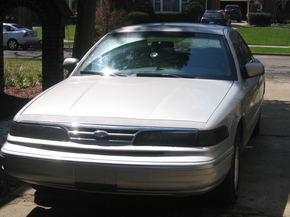 Silver sedan with a chrome grille and dark headlights, parked outdoors