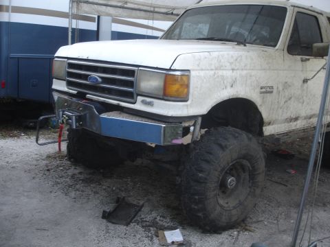 1989 Ford Bronco - This lifted Ford Bronco has a custom winch mount and is covered in dirt.