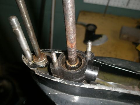 2007 Ford Bronco - Close-up of a boat motor's lower unit, showing rusty metal components and bolts.