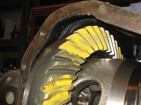 1990 Ford F-250 - Close-up of differential gears, likely during a rebuild or inspection process, showing yellow marking compound on the teeth.