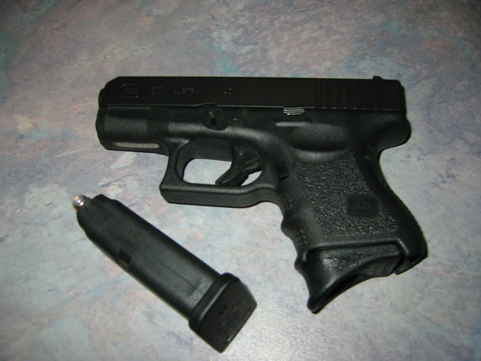 Black semi-automatic pistol with detached magazine