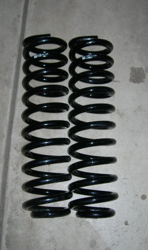 1985 Ford Bronco - A pair of black coil springs are shown, with a label visible on one of them.