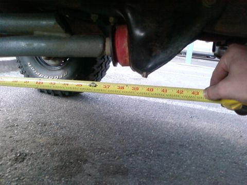 1995 Ford Bronco - A measuring tape is held against the undercarriage of a vehicle, with the tape reading around 43 inches.