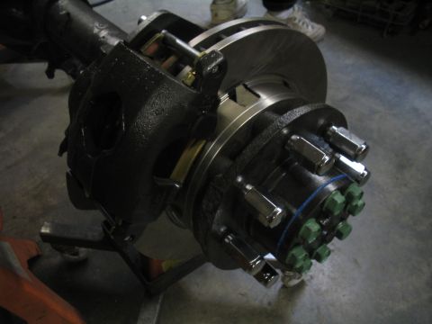 1979 Ford Bronco - Close-up of a heavy-duty axle assembly, showing a brake rotor, caliper, and a dual lug nut pattern.