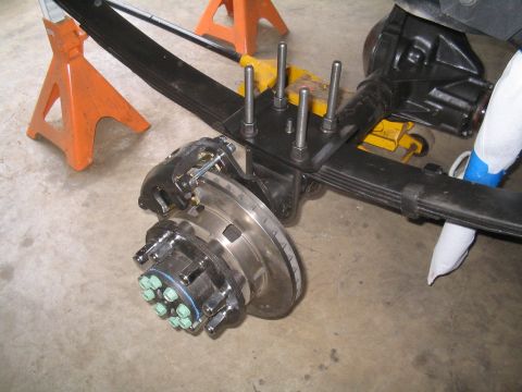 1979 Ford Bronco - Close-up of a vehicle's leaf spring and axle assembly, showing brake components.