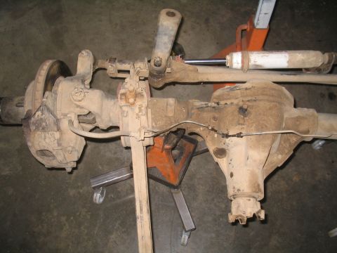 1979 Ford Bronco - Front axle assembly, likely from a 4x4 vehicle, is shown with its shock absorber and brake components.