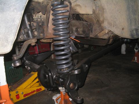 1979 Ford Bronco - Vehicle suspension components are visible, including a coil spring and steering linkage.