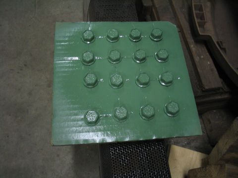 1979 Ford Bronco - A green metal plate with a grid of 16 bolts is shown, likely a component for a vehicle.