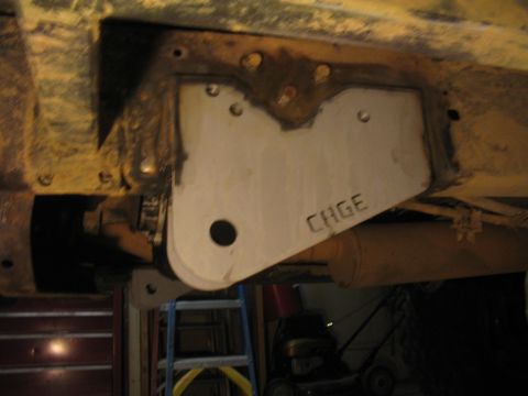 1979 Ford Bronco - A close-up view of a custom suspension component, possibly for a "1 ton swap", with the word "CAGE" stamped onto it.