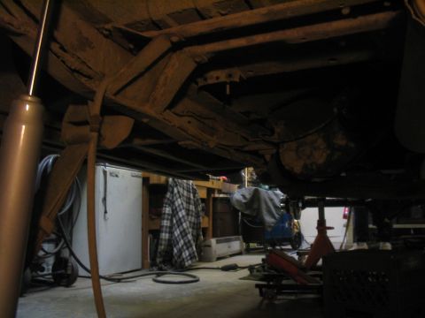 1979 Ford Bronco - Vehicle underbody with suspension components visible, possibly undergoing maintenance in a garage.