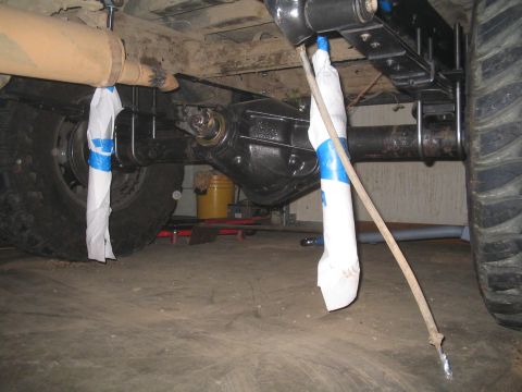 1979 Ford Bronco - Undercarriage view shows the rear axle assembly and suspension components of a vehicle.