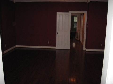 2006 Ford F-150 - Interior view of a room with dark wood floors and maroon walls, showing a doorway to a hallway.