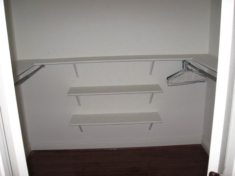 2006 Ford F-150 - Interior view of an empty closet white shelving and a clothes hanging rod.