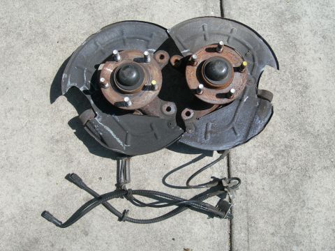 1992 Ford Taurus - Pair of front wheel hub assemblies with brake dust shields and ABS sensors.
