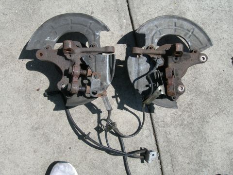 1992 Ford Taurus - These are two separate front wheel hub and brake assemblies, each with a brake rotor shield and ABS sensor.