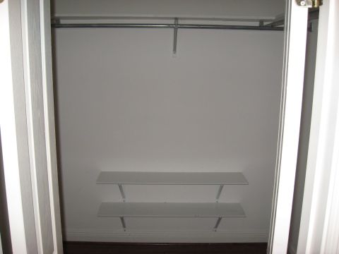 2006 Ford F-150 - An empty closet with a hanging rod and two shelves is viewed from an interior perspective.