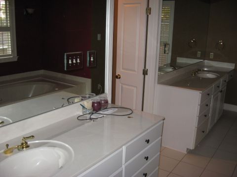 2006 Ford F-150 - A bathroom scene with a large mirror, a tub, and a double vanity with sinks and drawers.