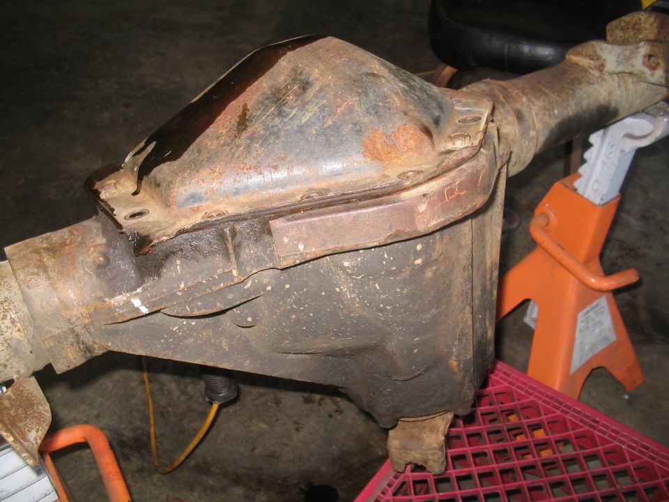 rusty rear axle differential housing on jack stands
