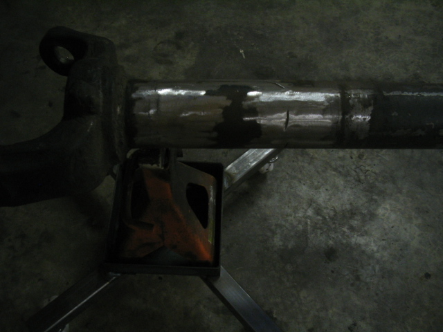 Axle housing on jack stand, showing welds