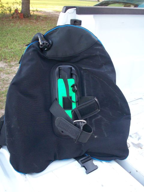 2006 Ford F-150 - A black scuba buoyancy compensator with blue trim is placed on the white surface of a truck bed.