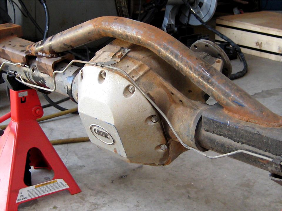 Ford Bronco rear axle assembly on red jack stands, showing a "KIRK" differential cover